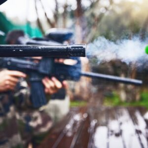 Explosion, shooting and person with paintball gun, ball and closeup of fun, extreme and sport, fitn